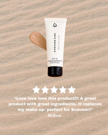 A tube of natural tinted moisturiser by avocado zinc sitting on a sandy background. 5 star review written underneath.