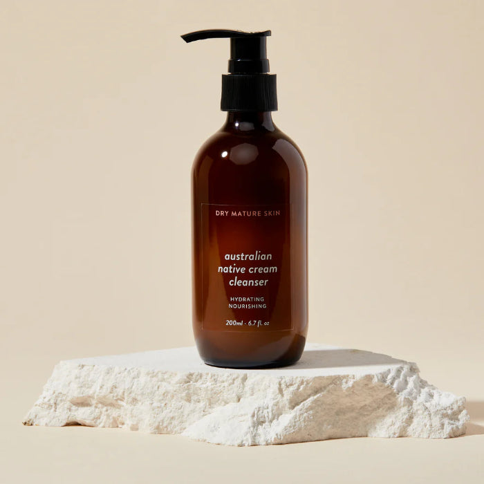 Brown bottle of natural face cleanser cream on a beige background