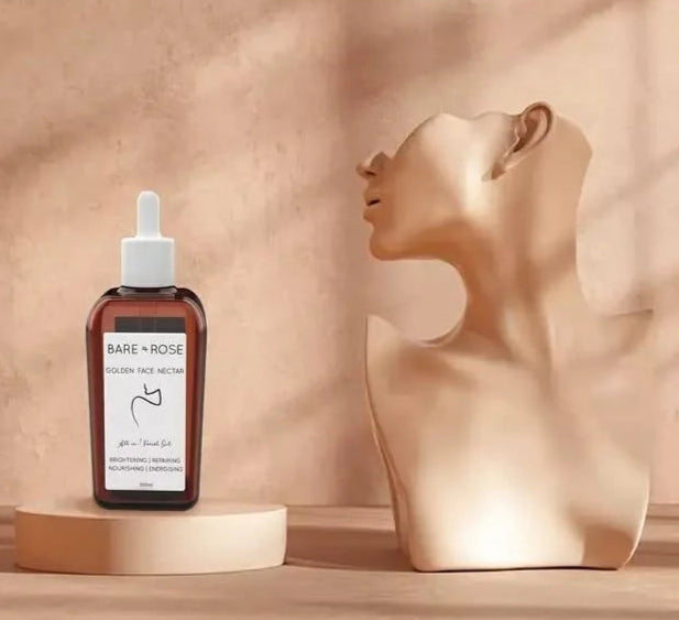 a bottle of organic face oil by bare and rose with a portrait sculpter.