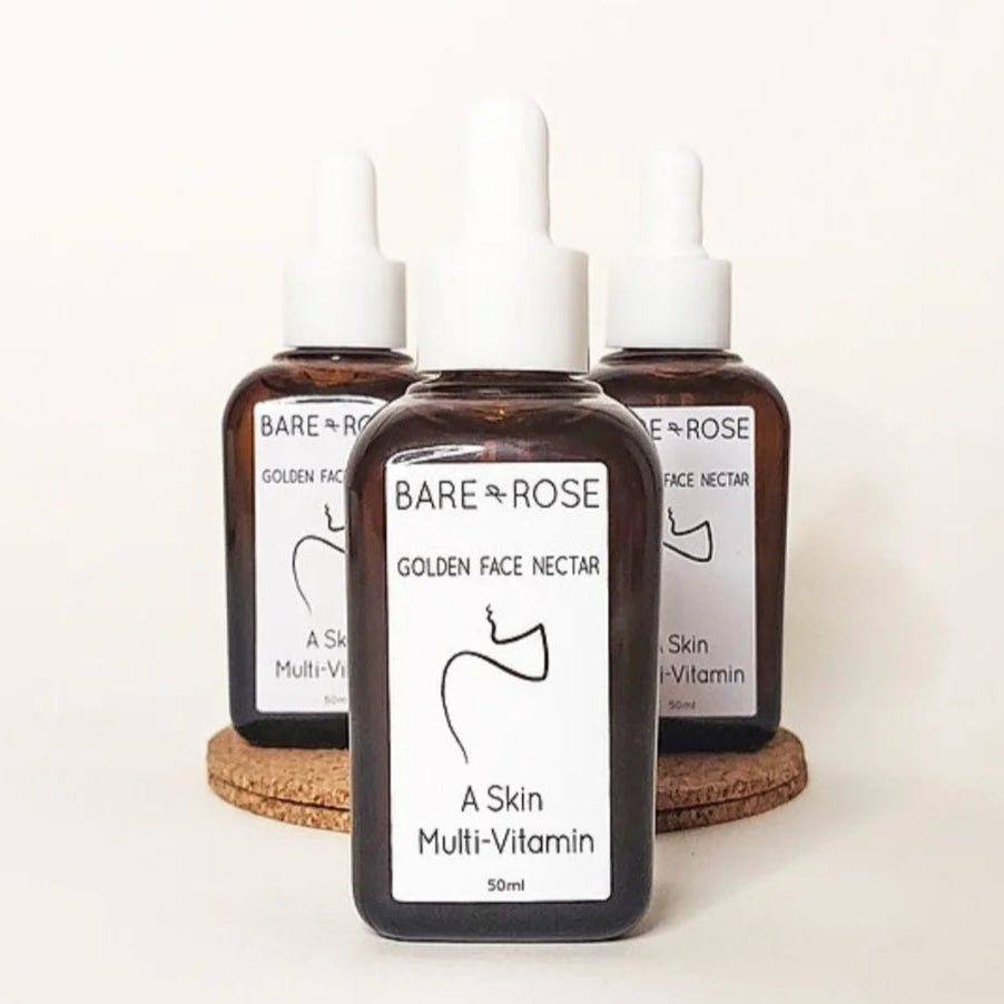 3 bottles of bare & rose organic face oil on a white background. 