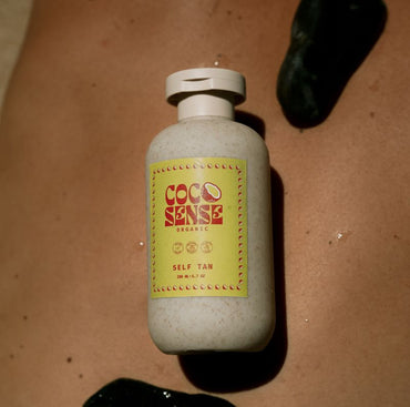 Bottle of Coco Sense self-tan cream on skin surface