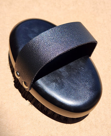 Black timber dry body brush with copper bristles and a faux leather handle